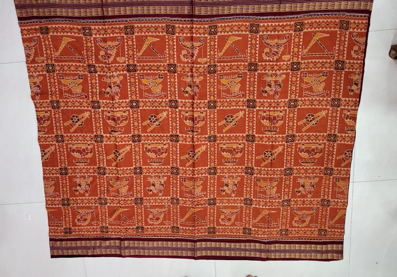 Brown and maroon handloom saree featuring a body pattern with royal elephant, horse, and farmer designs, blending tradition with elegance. Perfect for cultural occasions.