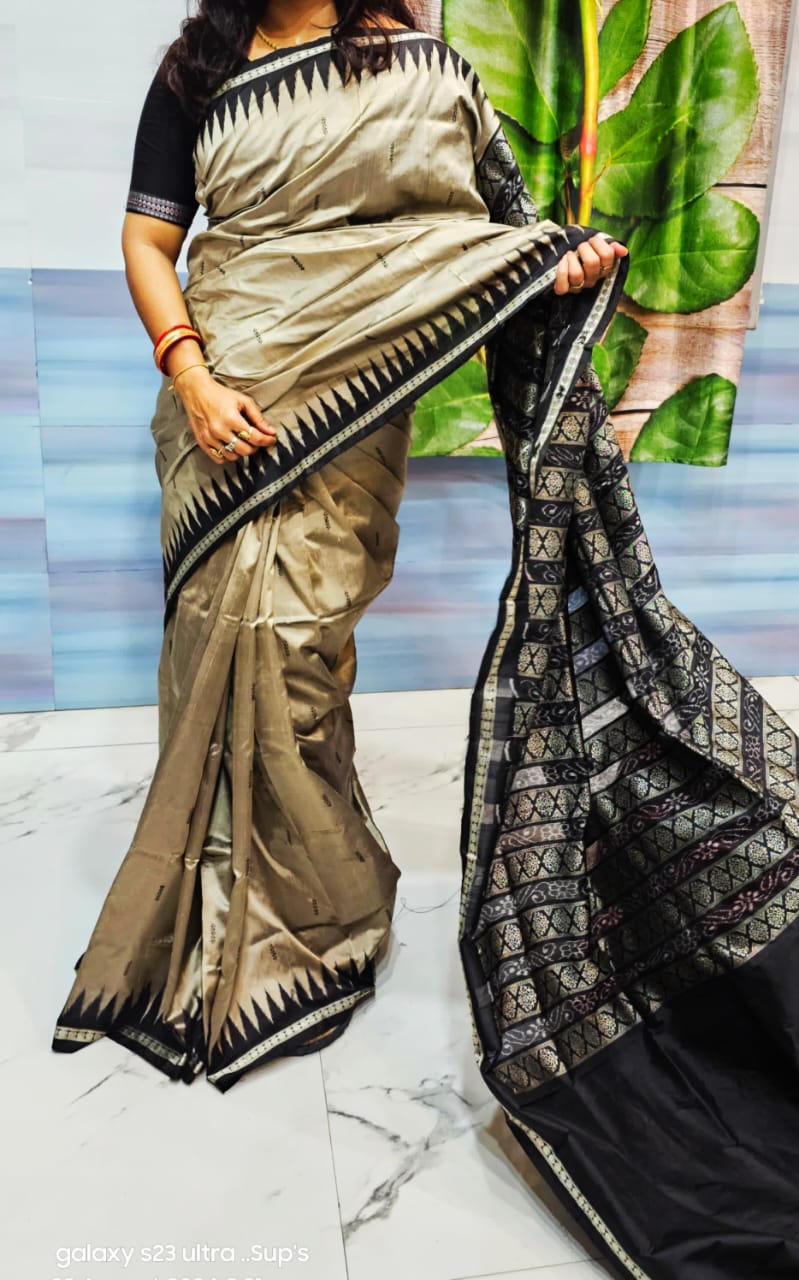 A graceful grey and black patta saree with a plain body design, complemented by a pallu adorned with small round floral motifs.